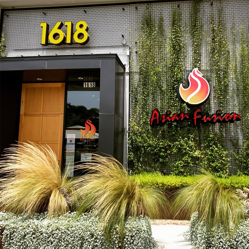Asian Fusion restaurant exterior with greenery, address 1618.
