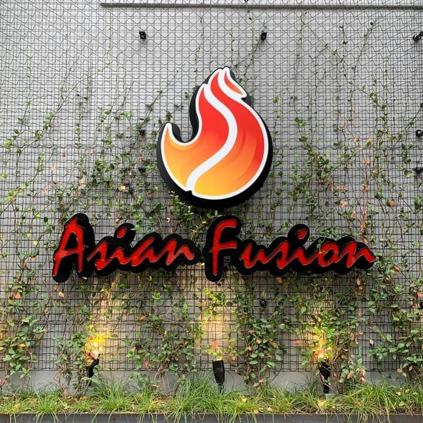 Logo of Asian Fusion restaurant with green vines on wall.
