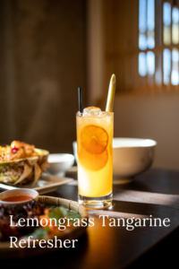 Iced lemongrass tangerine drink with lemon slice.