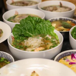 Bowls of noodle soup with lettuce garnish.