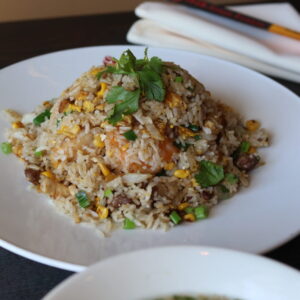 Plate of mixed fried rice with vegetables.