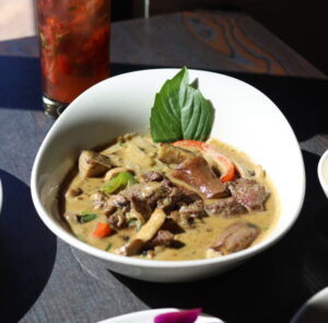 Bowl of Thai green curry with beef and vegetables.