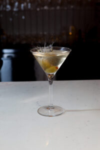 Martini glass with olive and splash effect